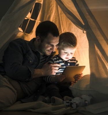 Man reading book and using phone